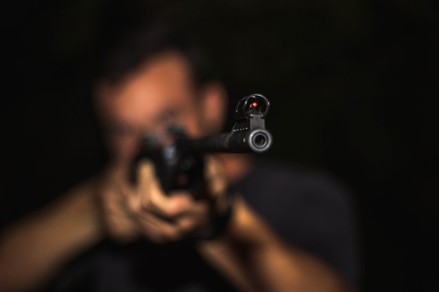 a guy aiming a gun