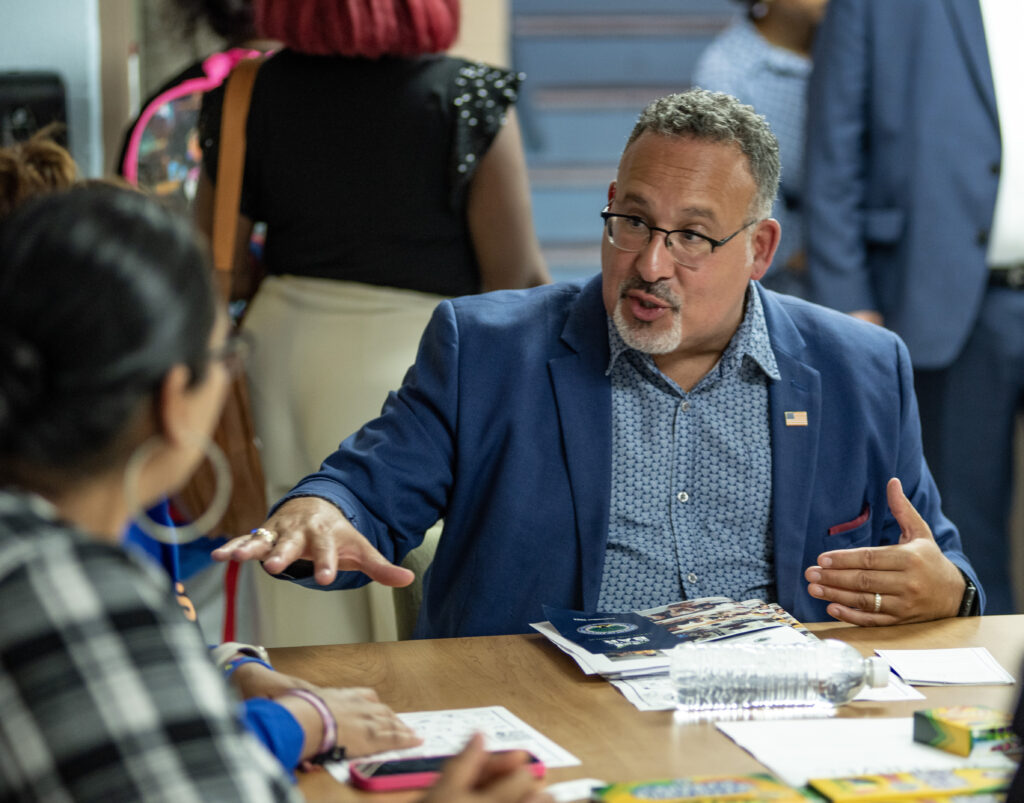 U.S. Secretary of Education Miguel Cardona speaks with families at the Mattie Rhodes Center in Kansas City, Missouri (Annelise Hanshaw/Missouri Independent)