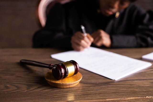 a gavel with a judge in the background 